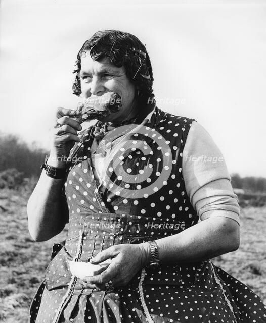 Gypsy woman eating, 1960s.