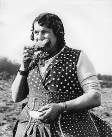 Gypsy woman eating, 1960s