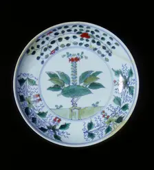 Doucai plate with pomegranate tree and floral groups, Qing dynasty, China, 1700-1722. Creator: Unknown