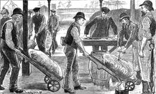 Dockers unloading sugar at West India Docks, London, 1889. Creator: Unknown
