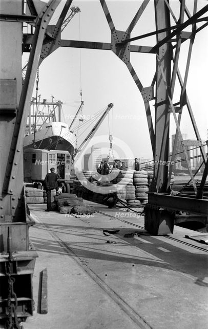 Dock workers and cargo, Royal Victoria Dock, London, c1945-c1965. Artist: SW Rawlings