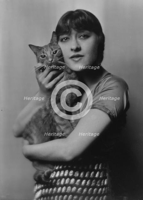 Dolly sister, with Buzzer the cat, portrait photograph, 1916. Creator: Arnold Genthe.