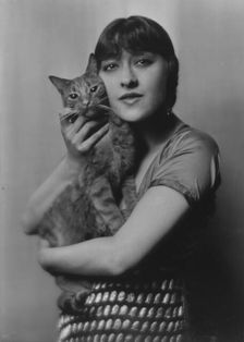Dolly sister, with Buzzer the cat, portrait photograph, 1916. Creator: Arnold Genthe