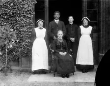 Domestic servants posing outside Pembroke College, Oxford, Oxfordshire, c1860-c1922. Artist: Henry Taunt
