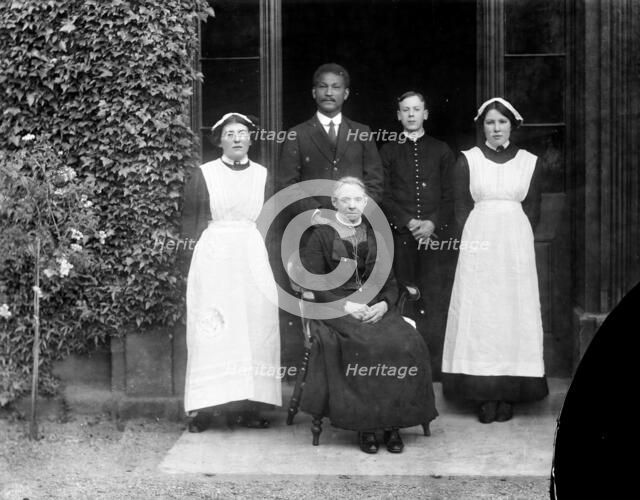 Domestic servants posing outside Pembroke College, Oxford, Oxfordshire, c1860-c1922. Artist: Henry Taunt