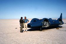 Donald Campbell being interviewed in front of Bluebird CN7, Lake Eyre, Australia, 1964. Creator: Unknown