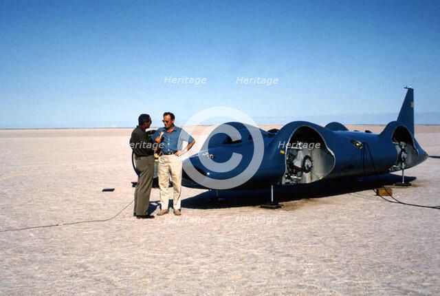 Donald Campbell being interviewed in front of Bluebird CN7, Lake Eyre, Australia, 1964. Creator: Unknown.