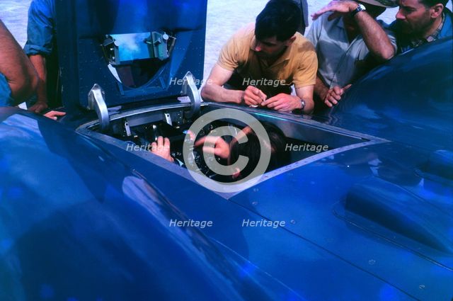 Donald Campbell in Bluebird CN7 cockpit at Lake Eyre 1963, Ken Norris on right. Creator: Unknown.