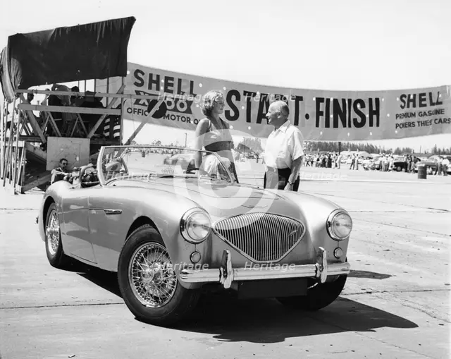 Donald Healey with an Austin Healey at a motor race. Artist: Unknown