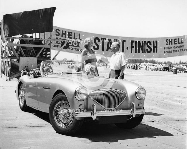 Donald Healey with an Austin Healey at a motor race. Artist: Unknown