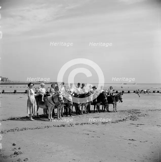 Donkey rides on the beach, Bridlington, East Riding of Yorkshire, 1950s. Artist: Hallam Ashley