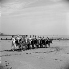Donkey rides on the beach, Bridlington, East Riding of Yorkshire, 1950s. Artist: Hallam Ashley