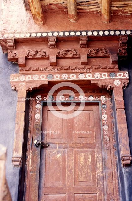 Door with skulls and faces, Ladakh, India, 1988. Creator: Amanda Waite.