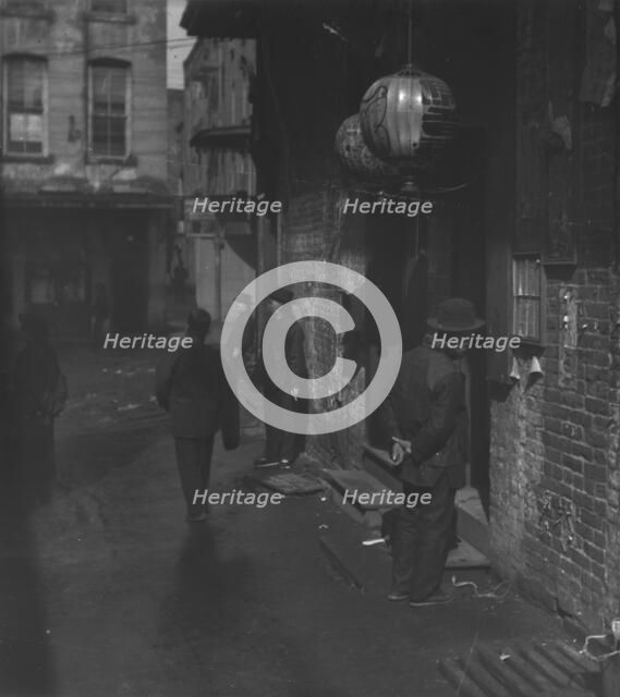 Doorways in dim shadows, Chinatown, San Francisco, between 1896 and 1906. Creator: Arnold Genthe.