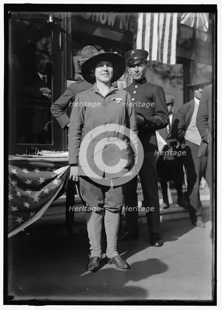 Dora Rodrigues, recruiter for service branches, possibly in front of the Cosmos Theater..., May 1917 Creator: Harris & Ewing.
