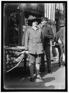 Dora Rodrigues, recruiter for service branches, possibly in front of the Cosmos Theater..., May 1917 Creator: Harris & Ewing