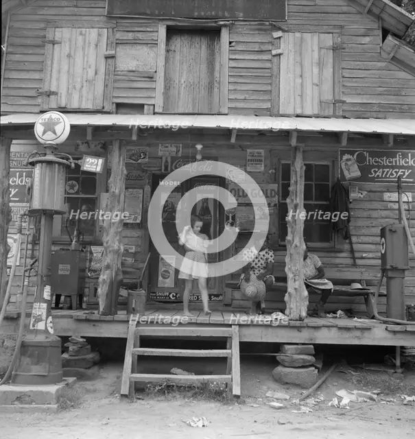 Daughter of white tobacco sharecropper at country store, Person County, North Carolina, 1939. Creator: Dorothea Lange.