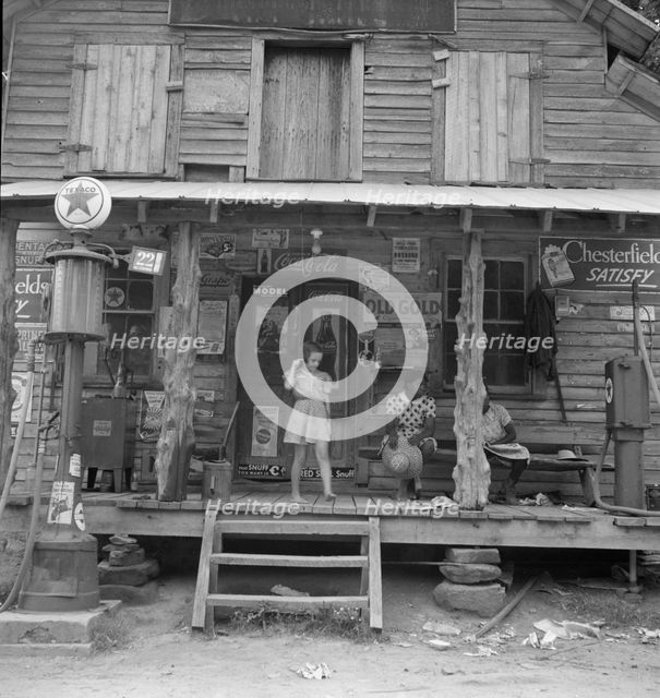 Daughter of white tobacco sharecropper at country store, Person County, North Carolina, 1939. Creator: Dorothea Lange.