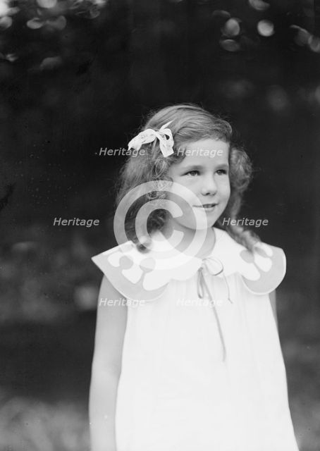 Daughter of W.G. Kimball, standing outdoors, between 1911 and 1942. Creator: Arnold Genthe.