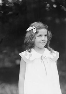 Daughter of W.G. Kimball, standing outdoors, between 1911 and 1942. Creator: Arnold Genthe
