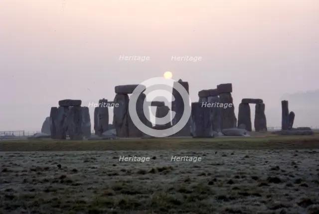 Dawn at Stonehenge, Wiltshire, c20th century. Artist: CM Dixon.