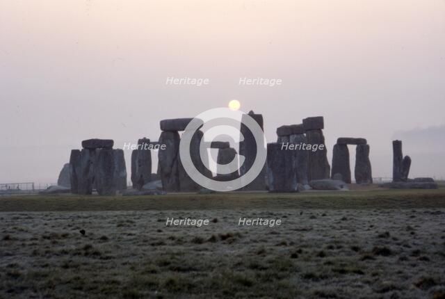 Dawn at Stonehenge, Wiltshire, c20th century. Artist: CM Dixon.