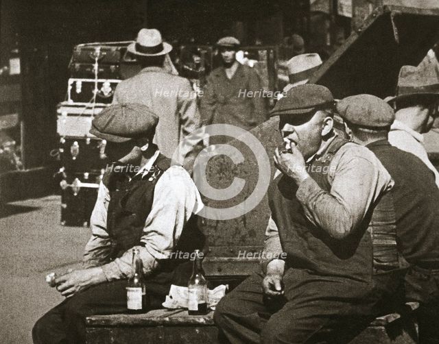 Day labourers having a hot dog and lemonade, Battery Park, New York, USA, early 1930s. Creator: Unknown.