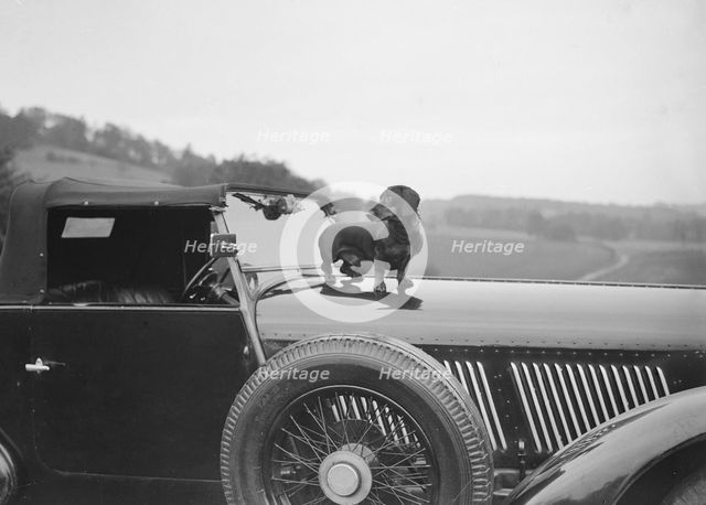 Dachshund standing on the bonnet of Charles Mortimer's Bentley, c1930s Artist: Bill Brunell.