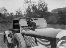Dachshund sitting on the bonnet of Charles Mortimer's Bentley, c1930s Artist: Bill Brunell