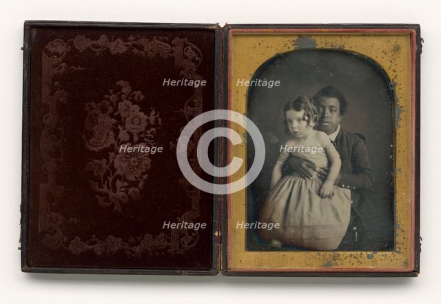 Daguerreotype of a boy holding a white baby, 1850s. Creator: Unknown.