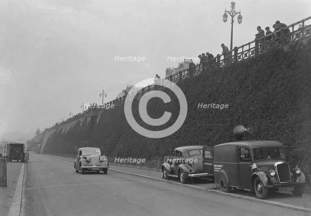 Daimler of CM Simpson and a Morris loudspeaker van on Madeira Drive, Brighton, RAC Rally, 1939. Artist: Bill Brunell.