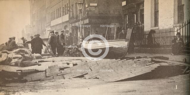 'Damage caused on the Victoria Embankment when the Thames burst its banks and caused a number of fat Artist: Unknown.