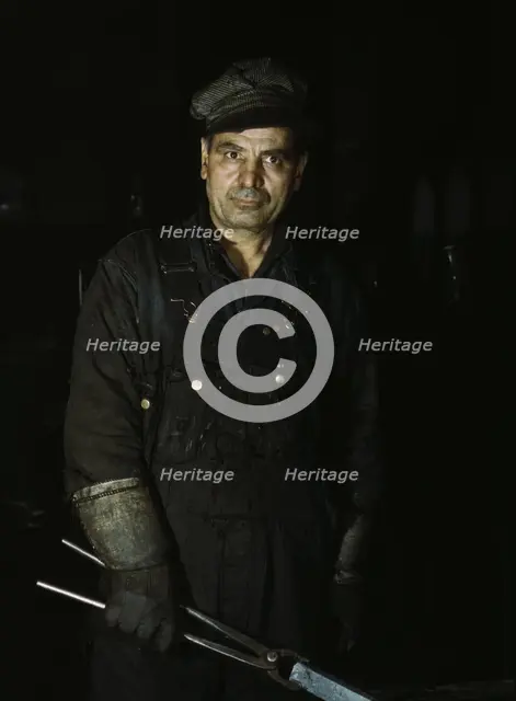 Daniel Anastazia, blacksmith's helper, Rock Island R.R., Blue Island, Ill., 1943. Creator: Jack Delano.