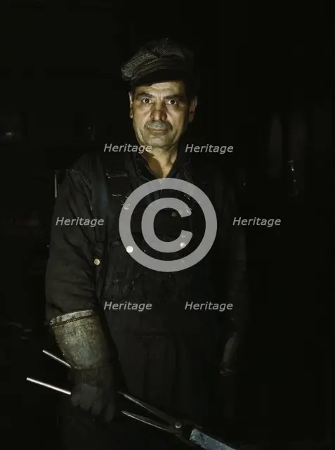 Daniel Anastazia, blacksmith's helper...roundhouse of the Rock Island R.R., Blue Island, Ill., 1943. Creator: Jack Delano.