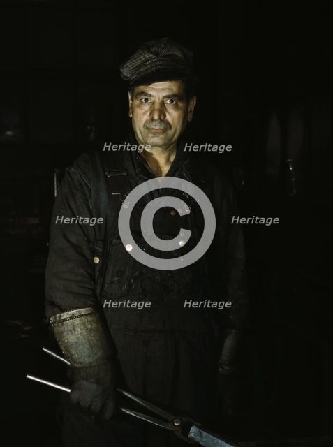 Daniel Anastazia, blacksmith's helper...roundhouse of the Rock Island R.R., Blue Island, Ill., 1943. Creator: Jack Delano.