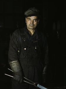 Daniel Anastazia, blacksmith's helper, Rock Island R.R., Blue Island, Ill., 1943. Creator: Jack Delano