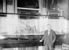 Daniels, Josephus, Secretary of The Navy, 1913-1921. with Model of U.S.S. New York, 1914. Creator: Harris & Ewing