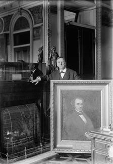 Daniels, Josephus, Secretary of The Navy, 1913-1921 with Painting of Secretary of The Navy..., 1913. Creator: Harris & Ewing