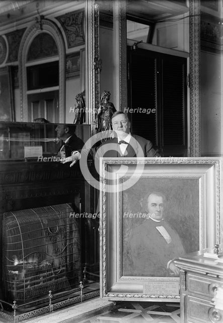 Daniels, Josephus, Secretary of The Navy, 1913-1921 with Painting of Secretary of The Navy..., 1913. Creator: Harris & Ewing.