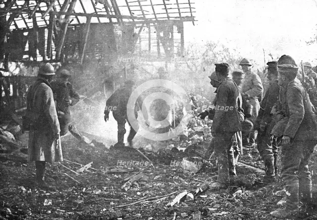 'Dans Cantigny; au milieu de la fumee des lance-flammes, les Allemands, un par un..., 1918. Creator: Unknown.