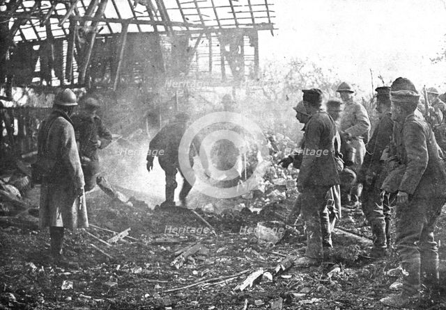 'Dans Cantigny; au milieu de la fumee des lance-flammes, les Allemands, un par un..., 1918. Creator: Unknown.