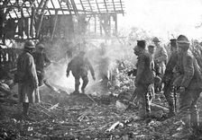 Dans Cantigny; au milieu de la fumee des lance-flammes, les Allemands, un par un..., 1918. Creator: Unknown