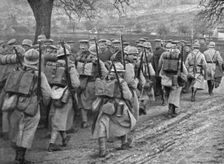 Dans la Bataille; Une releve d'infanterie qui monte en ligne se croise avec un convoi..., 1918. Creator: Unknown