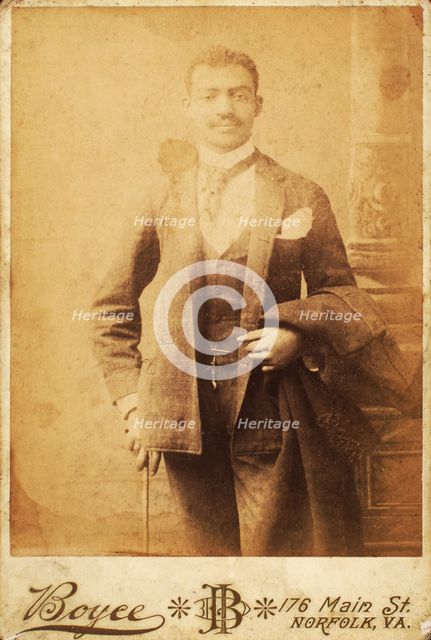 Dapper man, coat draped over his arm, and cane in hand, c1880-c1889. Creator: Unknown.