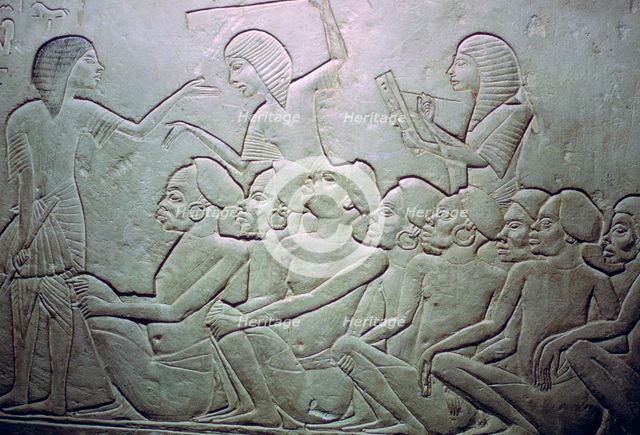 Detail of an Egyptian stele showing an overseer, slaves and scribe. Artist: Unknown
