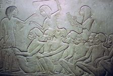 Detail of an Egyptian stele showing an overseer, slaves and scribe