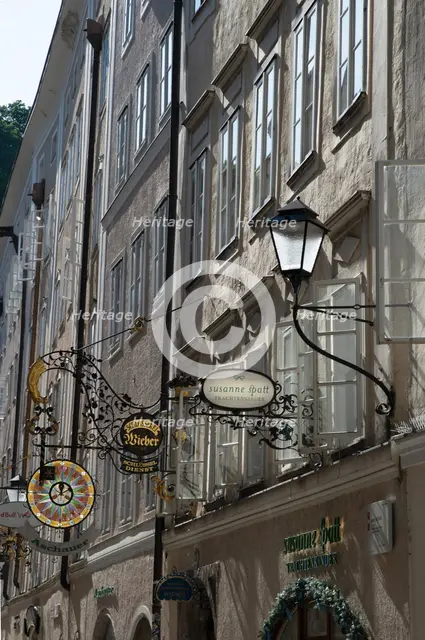 Detail view of the traditional signs along an old building on Getreidegasse, Salzburg, Austria, 2022 Creator: Ethel Davies.