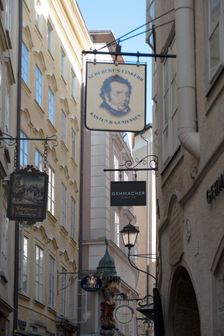 Detail view of the traditional signs along an old building on Getreidegasse, Salzburg, Austria, 2022 Creator: Ethel Davies