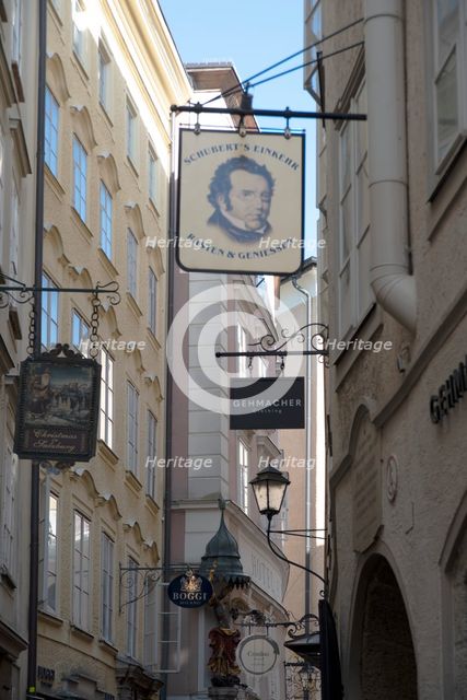 Detail view of the traditional signs along an old building on Getreidegasse, Salzburg, Austria, 2022 Creator: Ethel Davies.