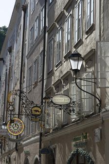 Detail view of the traditional signs along an old building on Getreidegasse, Salzburg, Austria, 2022 Creator: Ethel Davies